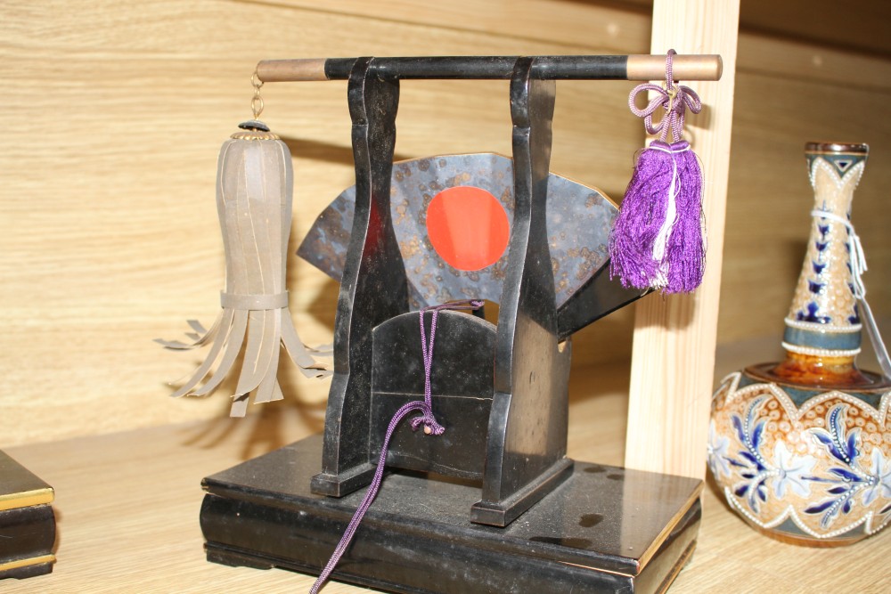 A Japanese late Meiji period composition and fabric figure of a boy farmer holding an adze with puppy seated nearby, mounted on display